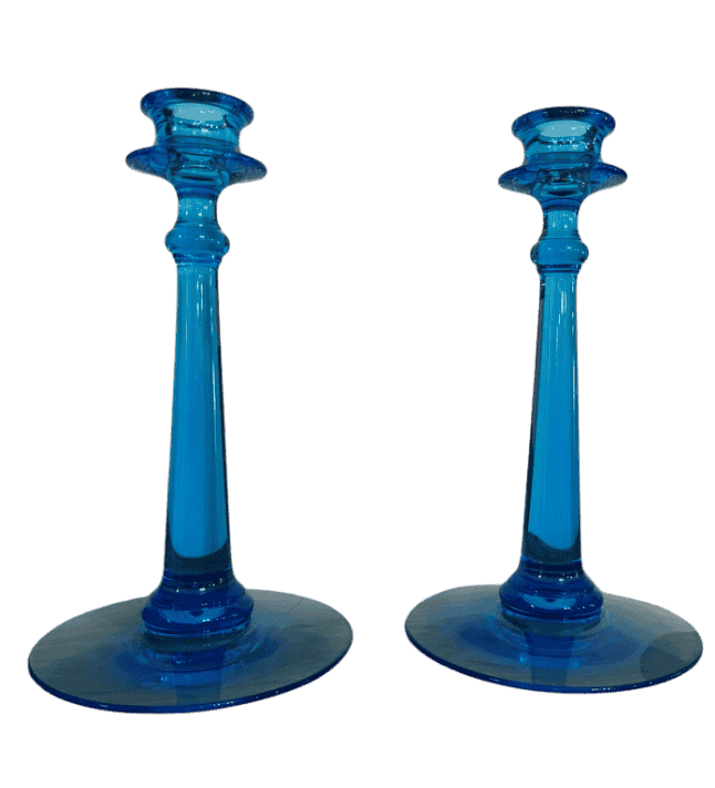 Angled front view of matching Fenton blue art glass candlesticks highlighting tall stems and saturated color.