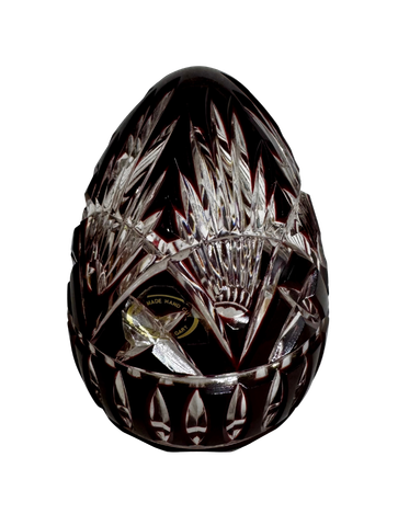 Back view of the hand-cut Hungarian ruby crystal egg showing its geometric pattern and partially visible black-and-gold label