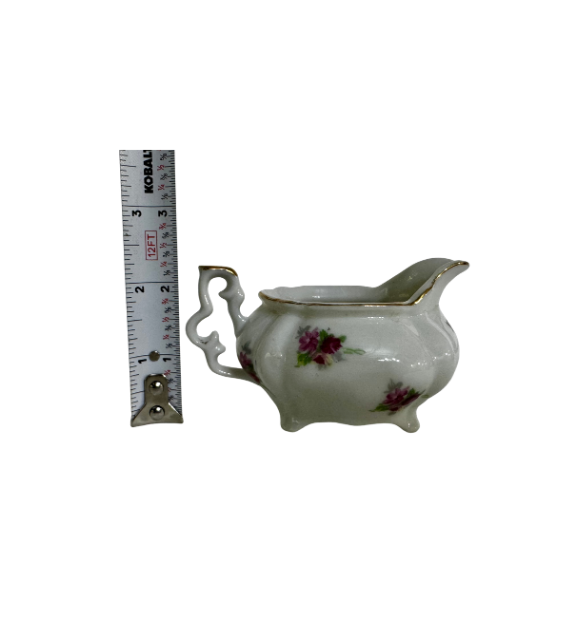 Vintage ESCO floral creamer beside a tape measure showing a height of approximately 2½ inches