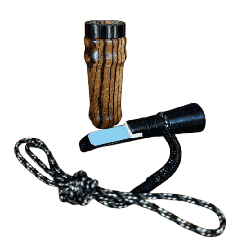 Zebrawood J. Baker Louisiana single reed duck call shown disassembled with barrel, insert, reed, and braided black and white lanyard.