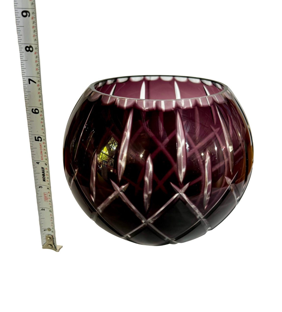 Bohemian amethyst cut-to-clear crystal rose bowl beside a tape measure showing an approximate 6.25-inch height