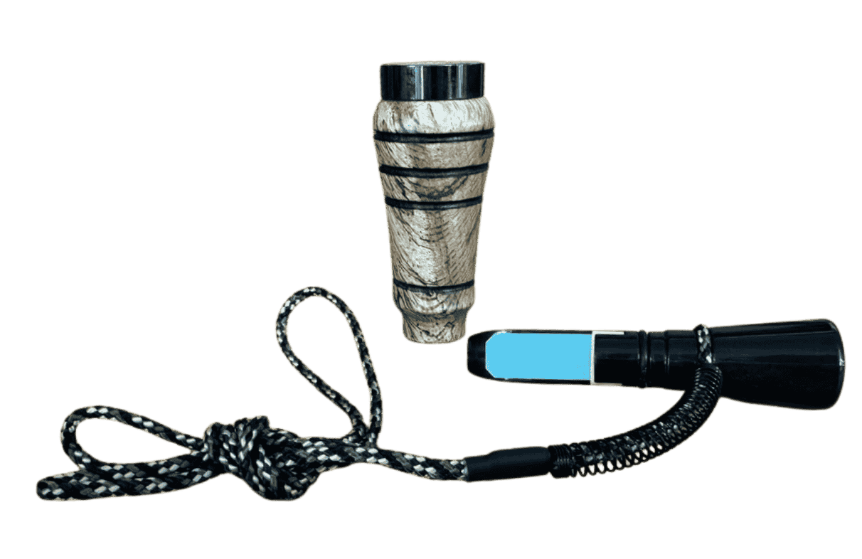 Spalted oak J. Baker Louisiana single reed duck call shown disassembled with barrel, insert, reed, and braided black and white lanyard.