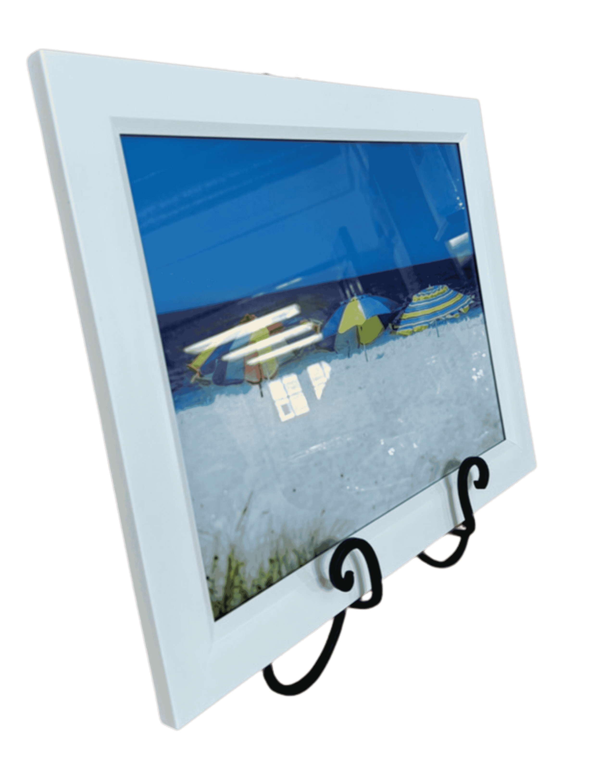 Framed beach photograph with colorful umbrellas on white sand and blue ocean.