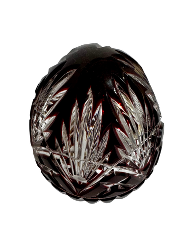 op view of a Hungarian ruby cut-to-clear crystal egg with clear spear and fan cuts radiating through the red crystal