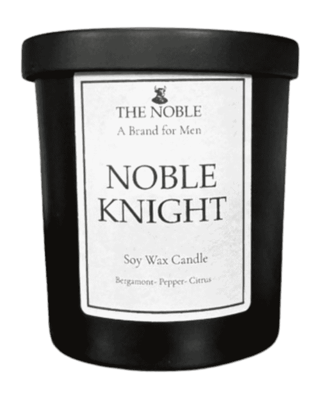Close-up detail of The Noble Noble Knight candle label showing soy wax candle branding and fragrance notes bergamot, pepper, and citrus.