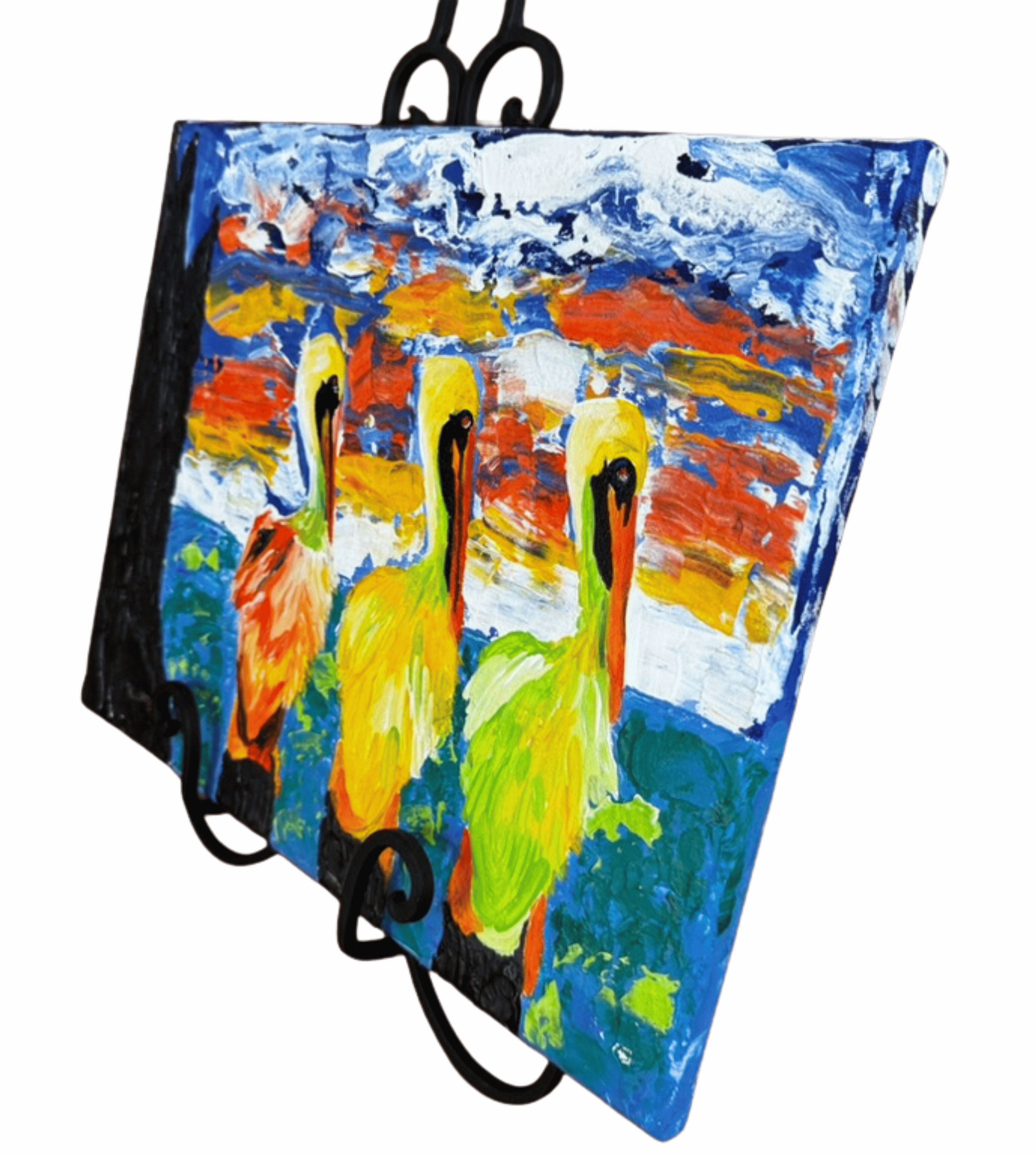 Angled view of three pelicans painting by R. Gates with vivid sky and ocean tones.