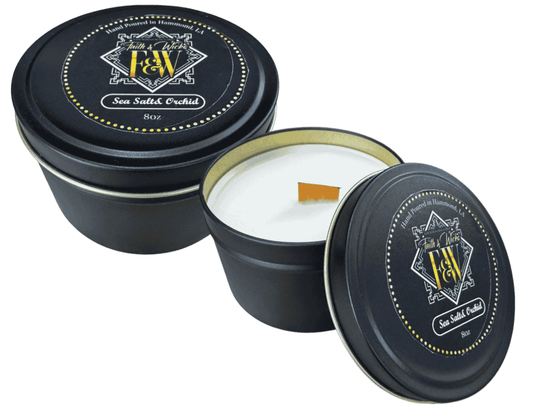 Faith & Wicks Sea Salt Orchid scented tin candle with black tin, gold label, and wood wick candle shown open with lid nearby