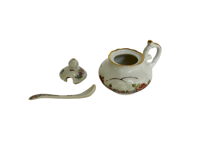 Open gumbo filé ceramic server displayed with its removable floral lid and matching curved spoon