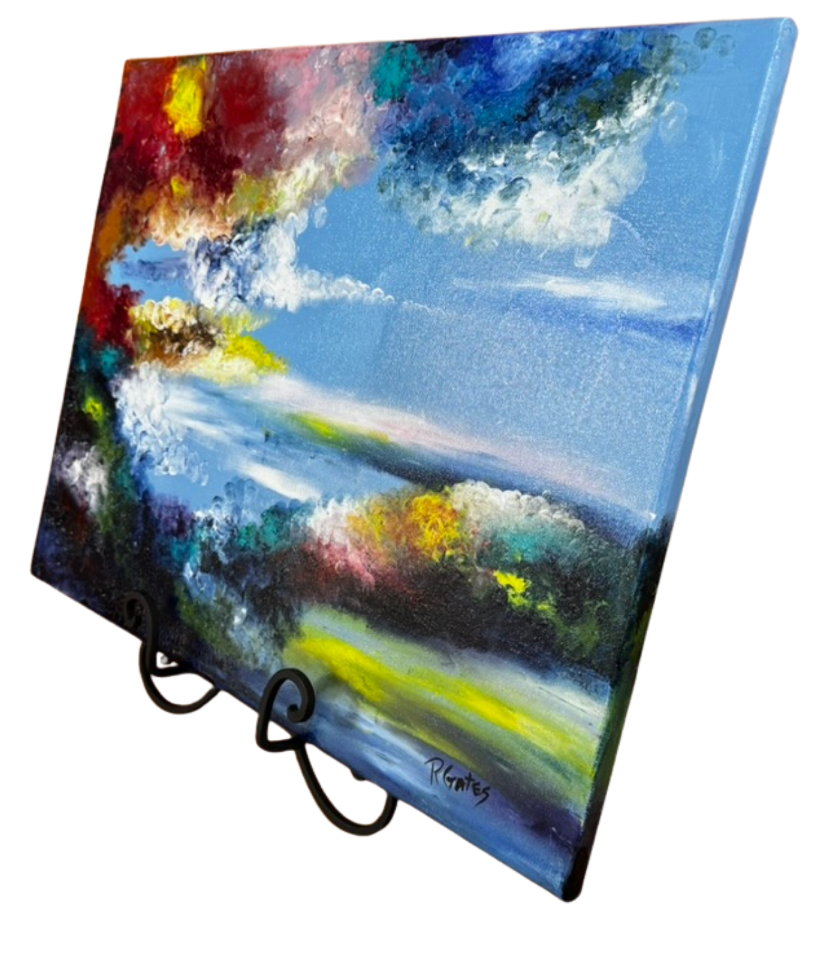 Side perspective of original acrylic artwork by R. Gates featuring colorful foliage, blue skies, and a tranquil waterside landscape rendered with expressive brushwork.