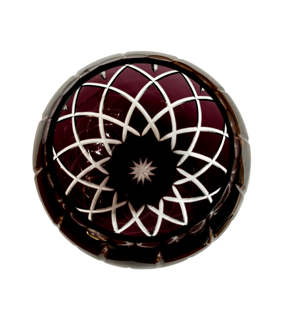 Top view inside a Bohemian amethyst crystal rose bowl showing interlocking clear lattice cuts and a central starburst