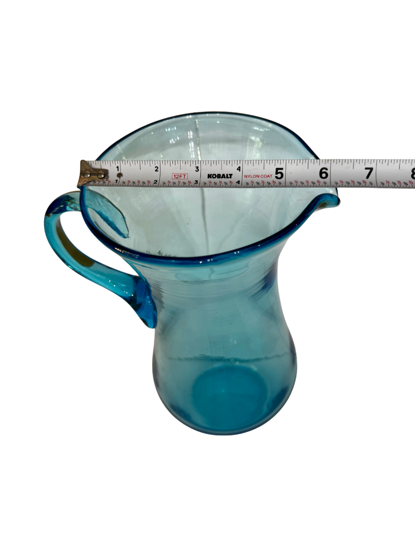 Top view of an antique aqua glass pitcher showing an approximate 6.25-inch rim and spout span