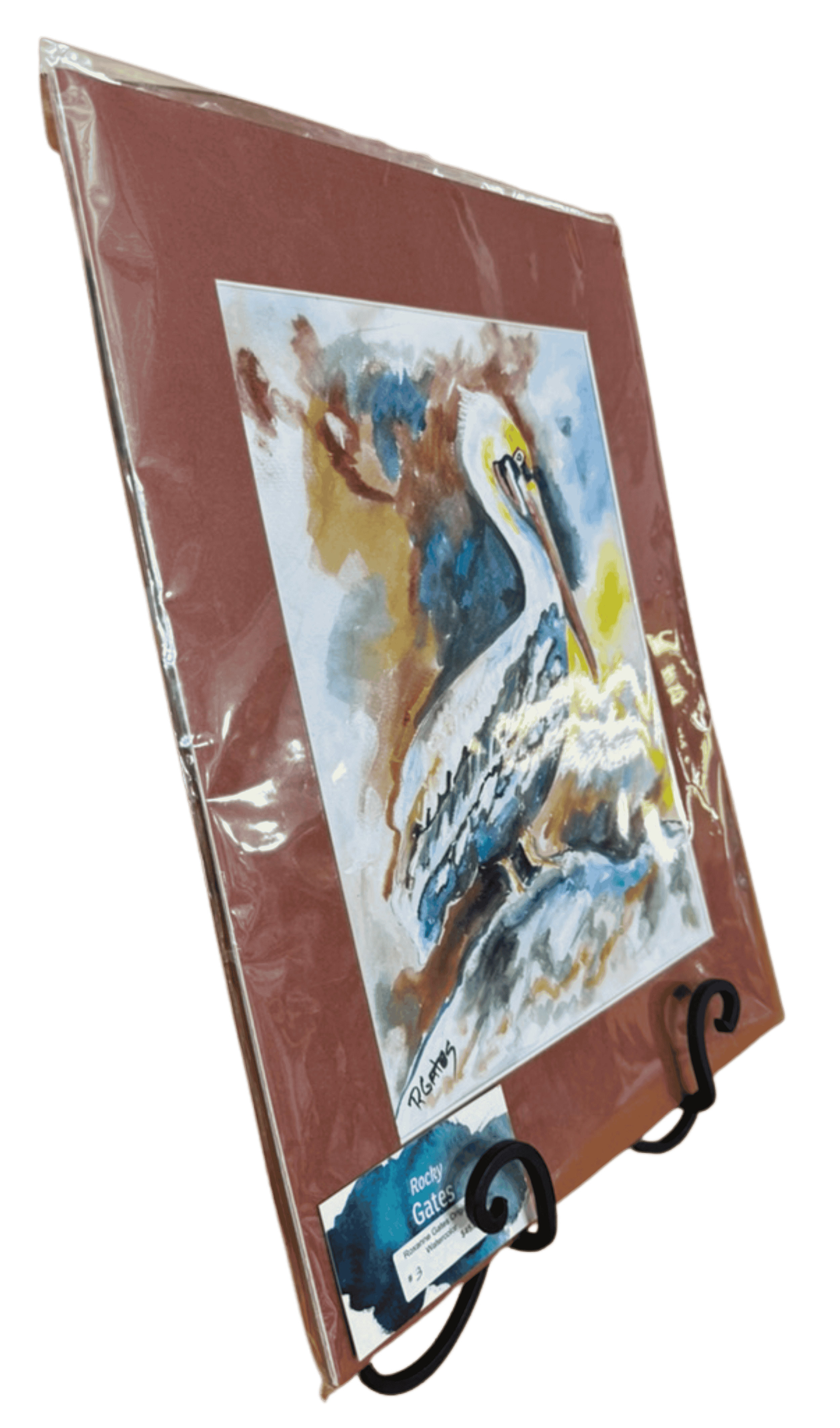 Angled view of R. Gates pelican watercolor painting with warm abstract background and perched coastal pelican.