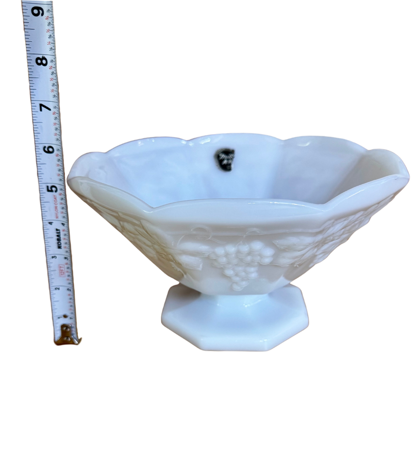 Vintage Anchor Hocking grape-pattern milk glass pedestal bowl beside a tape measure showing its approximate 5-inch height