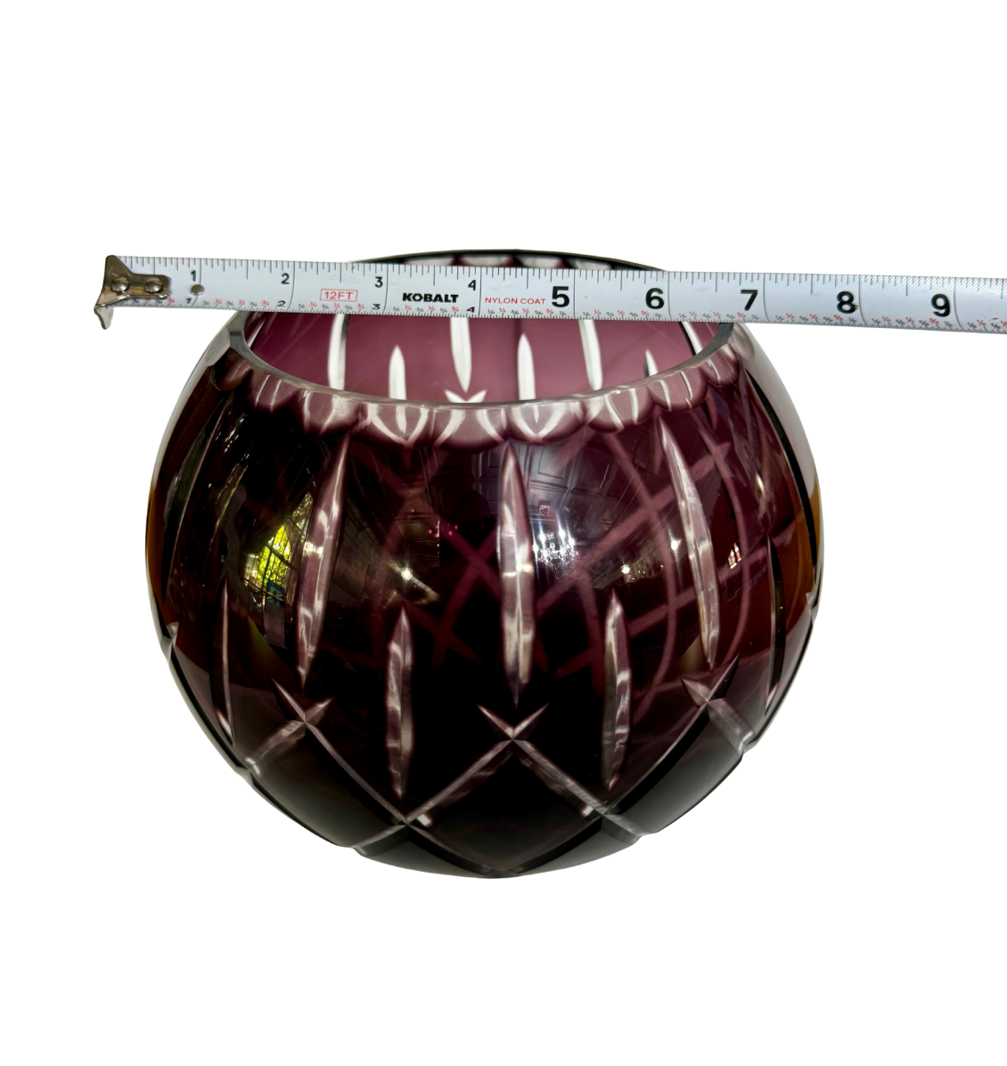 Bohemian amethyst cut-to-clear crystal rose bowl with a tape measure showing an approximate 7-inch width