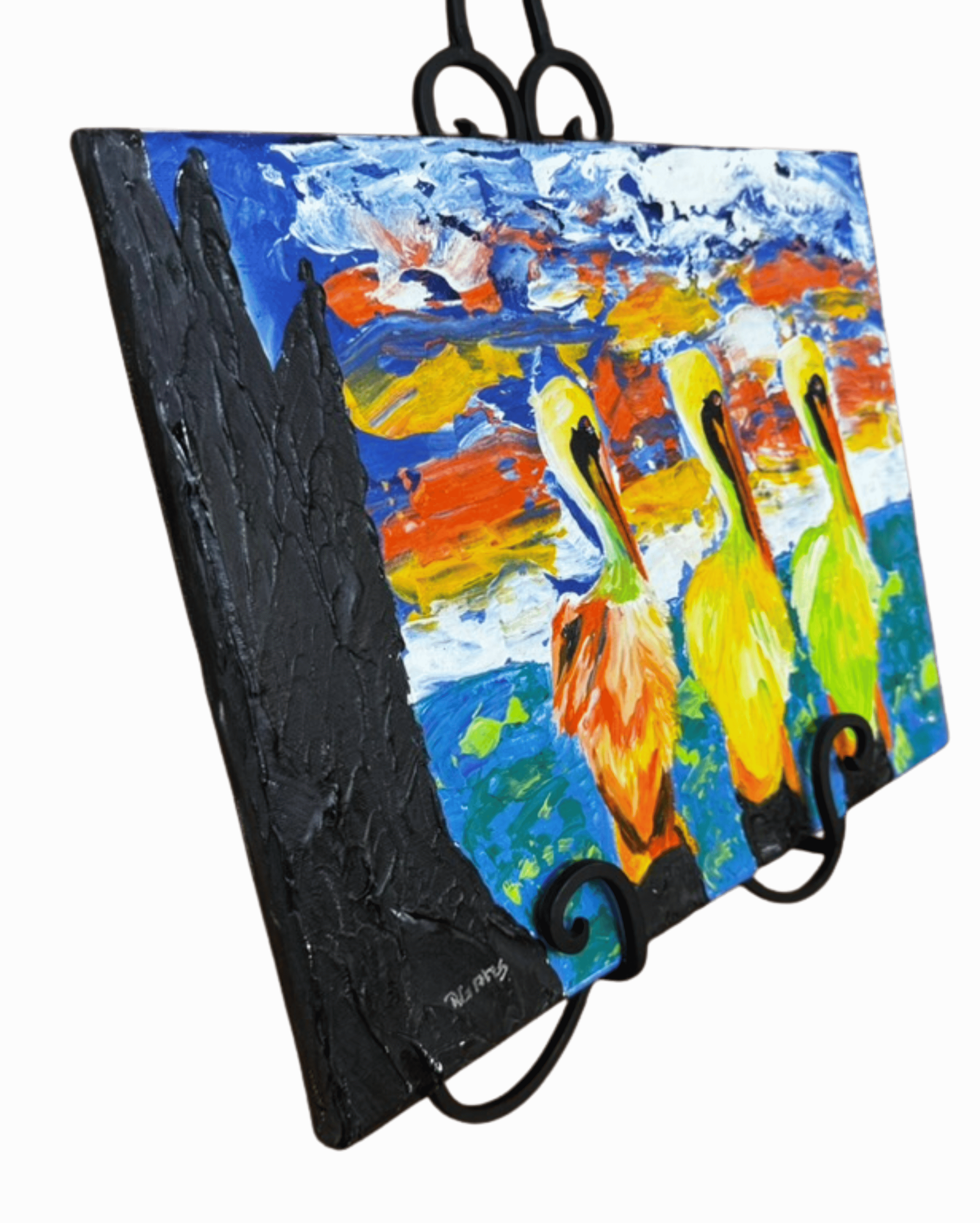 Original pelican painting by R. Gates showing three colorful pelicans against a vibrant sunset sky.