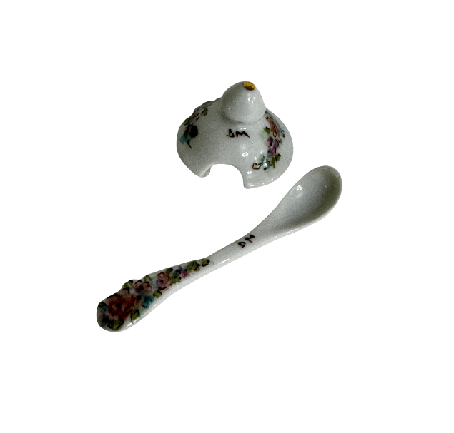 Matching floral ceramic lid and spoon from a signed 1992 gumbo filé server, both marked with the artist’s initials