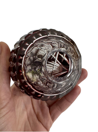 Underside of the hollow Hungarian ruby crystal egg showing its circular opening, thick clear crystal, and surrounding cut pattern