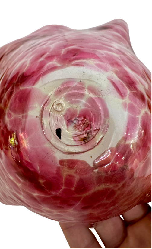 Underside of an Orbix hand-blown glass bowl showing the hot-stamped studio logo, pontil, and base wear