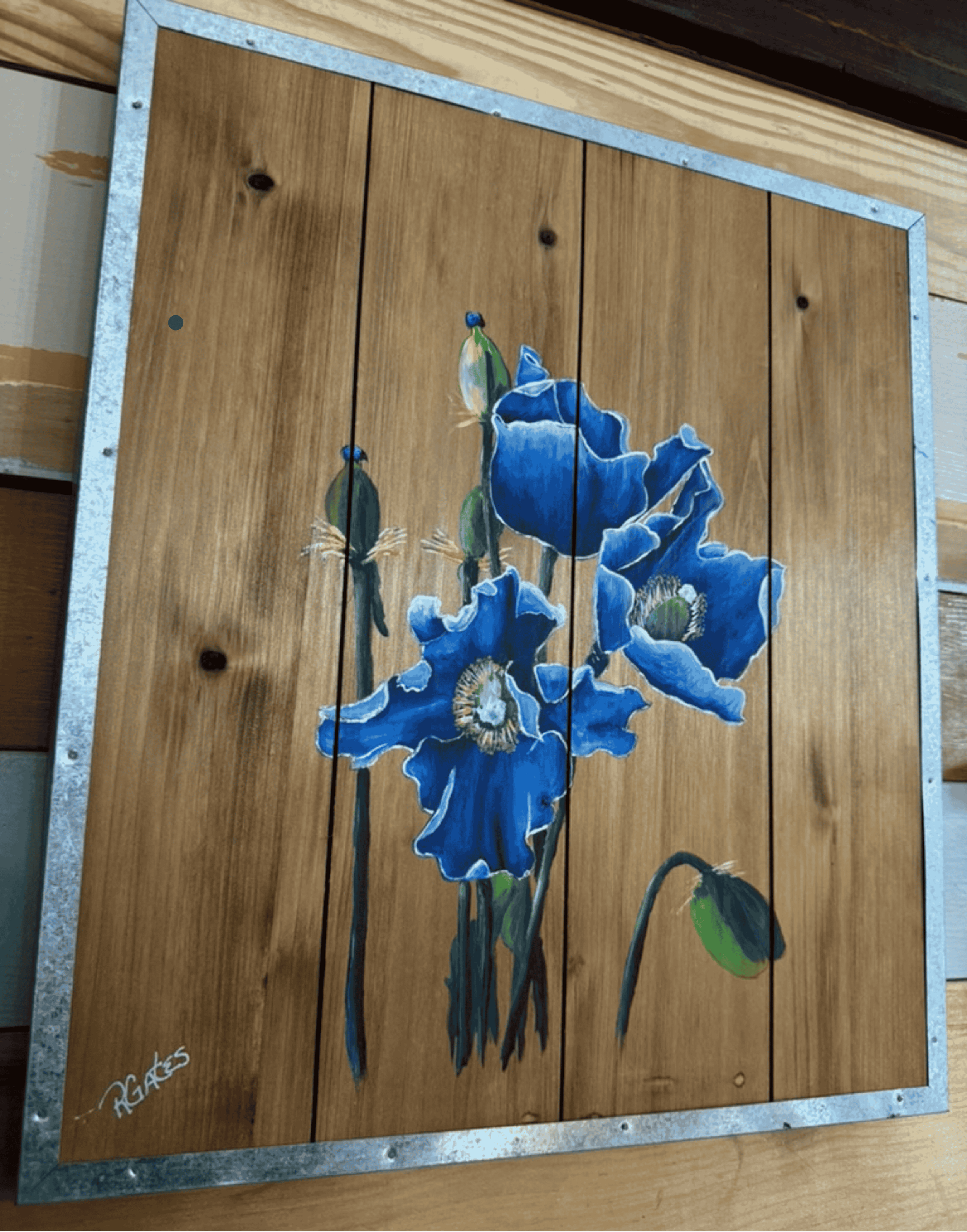 Angled view of blue iris artwork by R. Gates highlighting painted wood plank construction, floral details, and rustic metal framing.