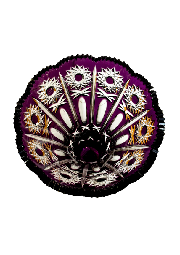 Top view inside a Bohemian amethyst cut-to-clear crystal vase showing repeating hobstars, elongated cuts, and a sawtooth rim