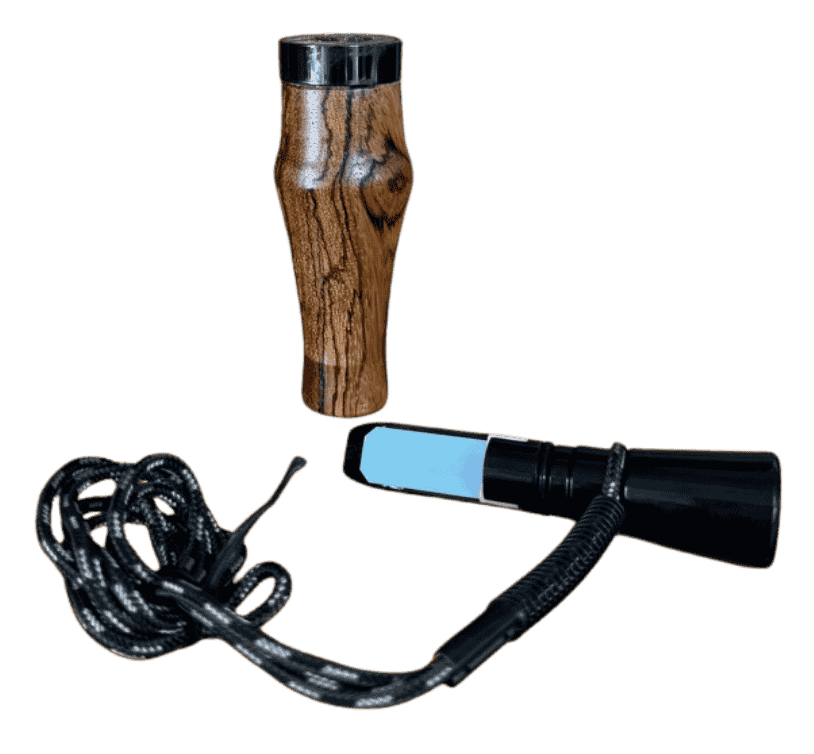 Zebrawood J. Baker Louisiana single reed duck call shown disassembled with barrel, insert, reed, and braided black and white lanyard.