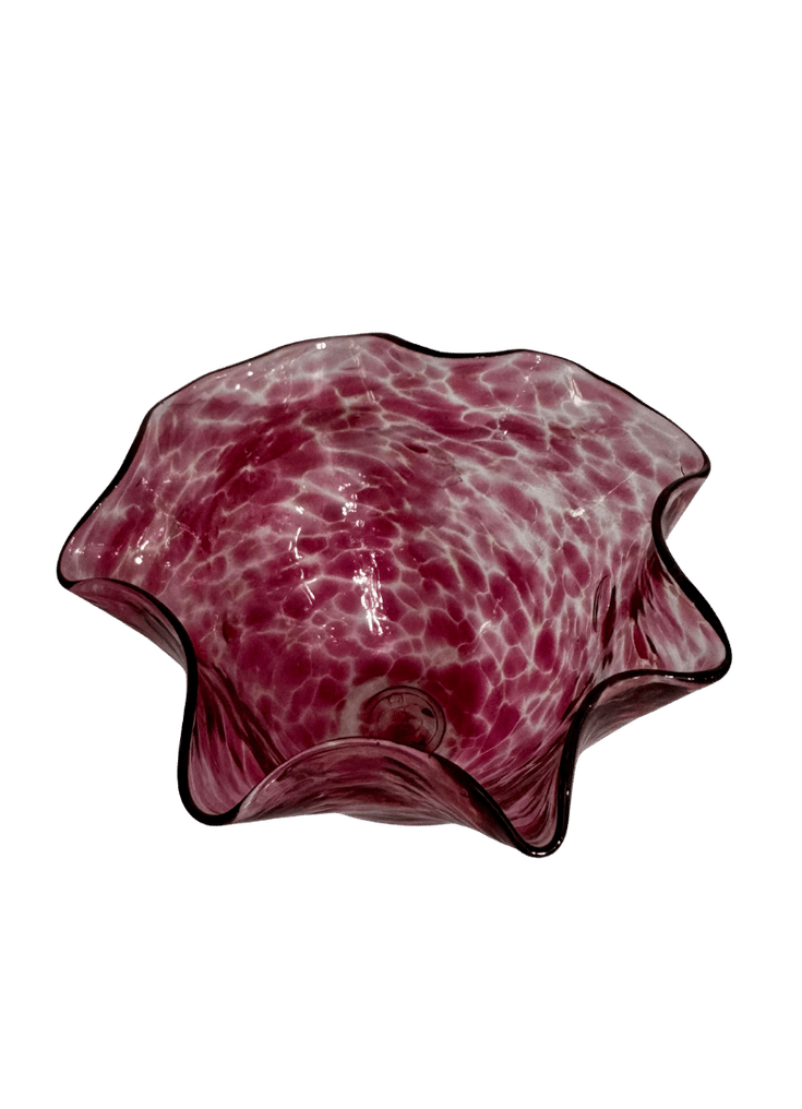 Top view of a signed Orbix raspberry-pink glass bowl showing its luminous mottled color and petal-shaped ruffled rim