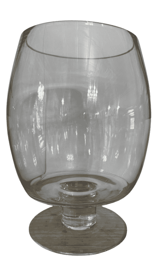 Close-up of vintage clear glass hurricane vase highlighting rounded bowl and pedestal foot.