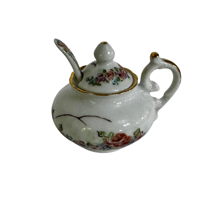 Back view of the floral gumbo filé server showing its curling handle, gilded lid, and matching ceramic spoon