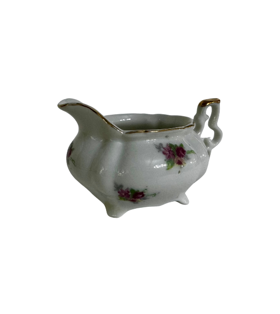 Angled view of the floral ESCO porcelain creamer showing its raised pouring spout and softly rounded body