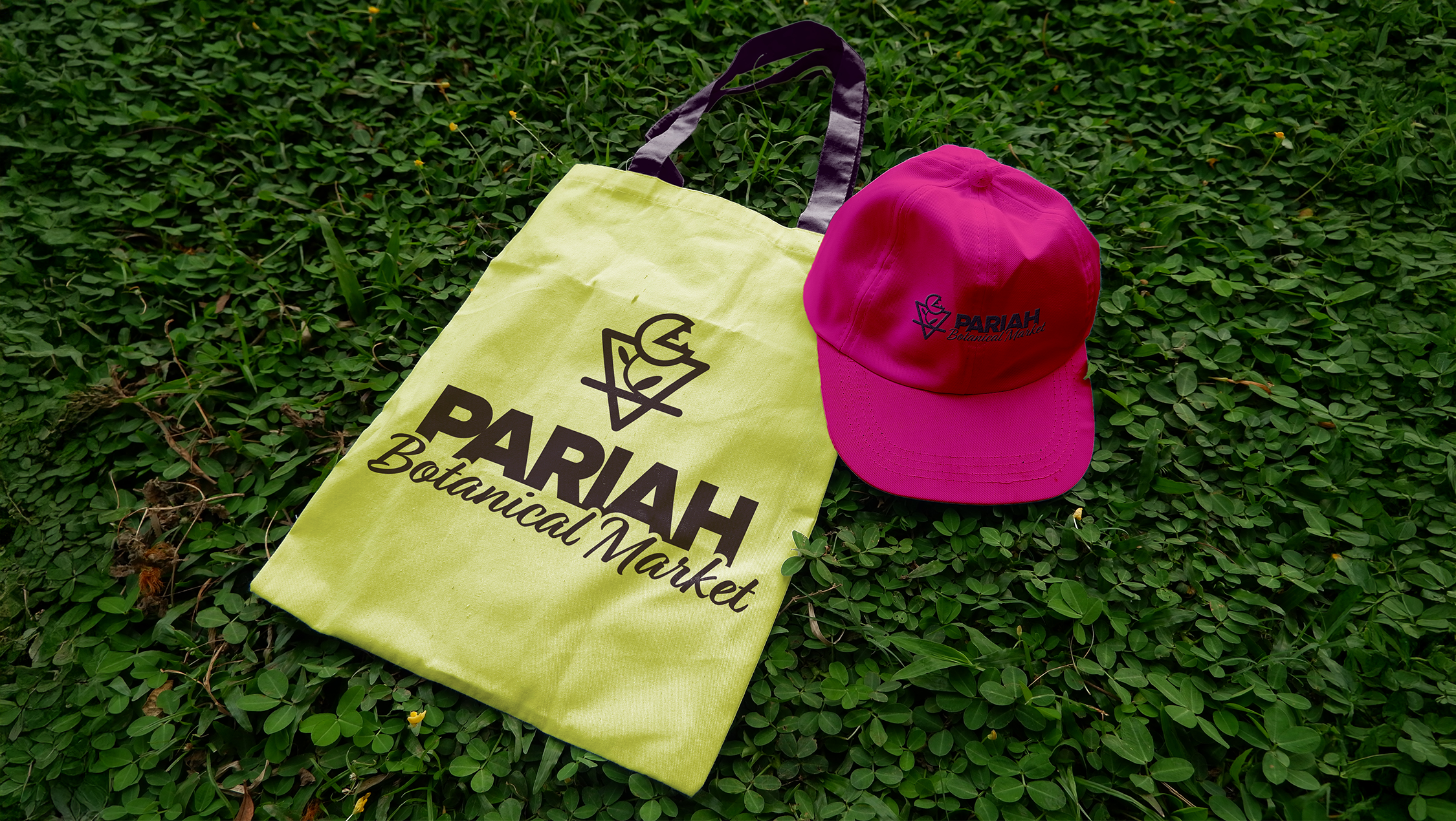 Pariah branded hat and reusable bag on clover