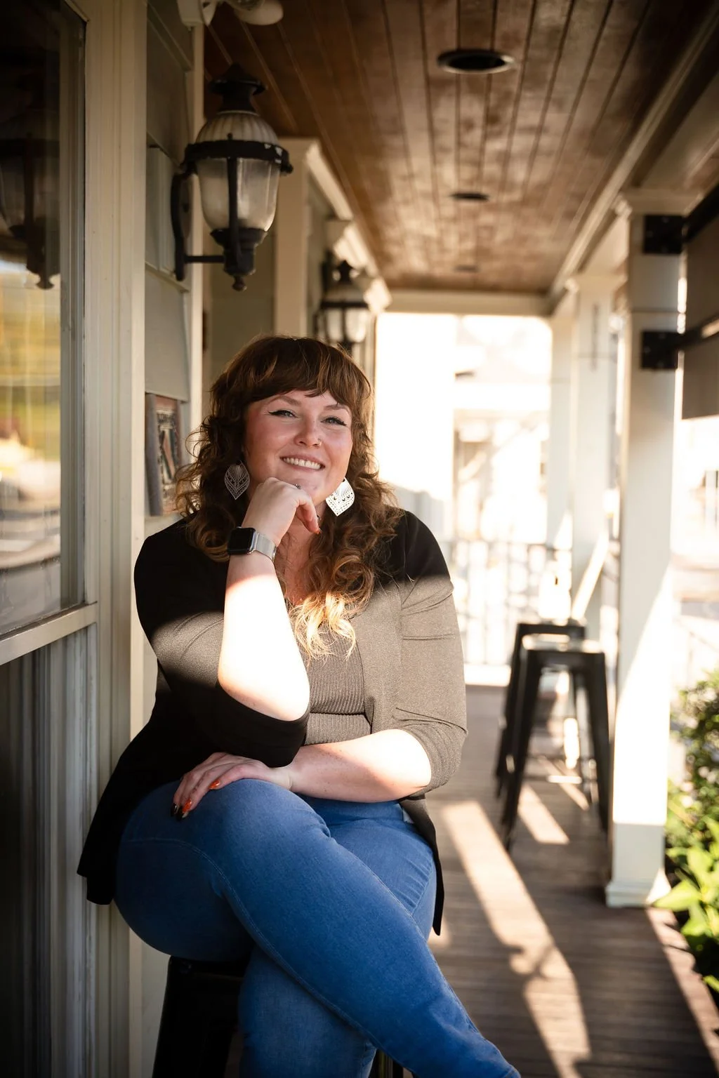 Photo of Felicia, leaning on knee smiling