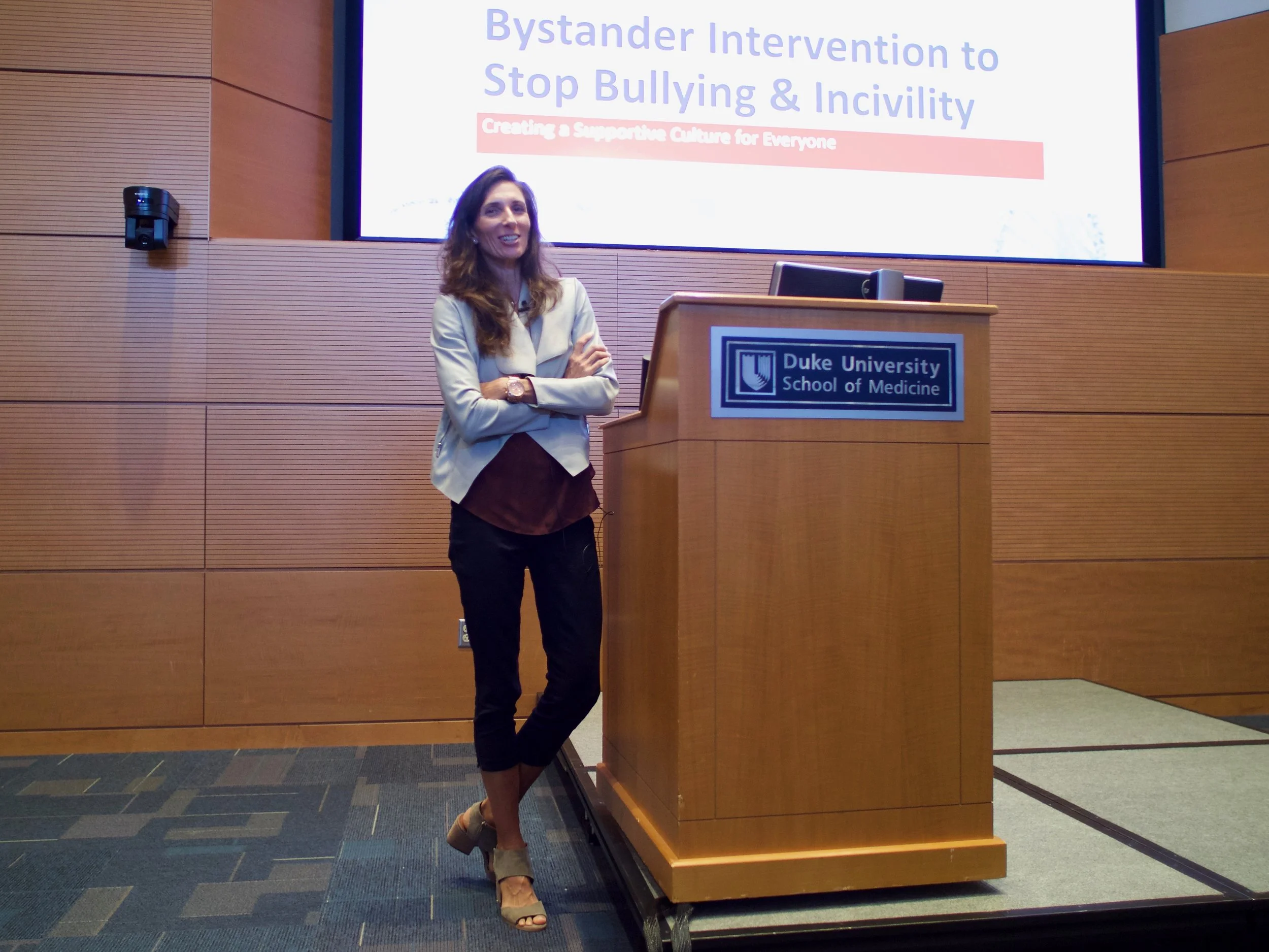 Ada Gregory standing next to a podium at Duke University School of Medicine giving a presentation