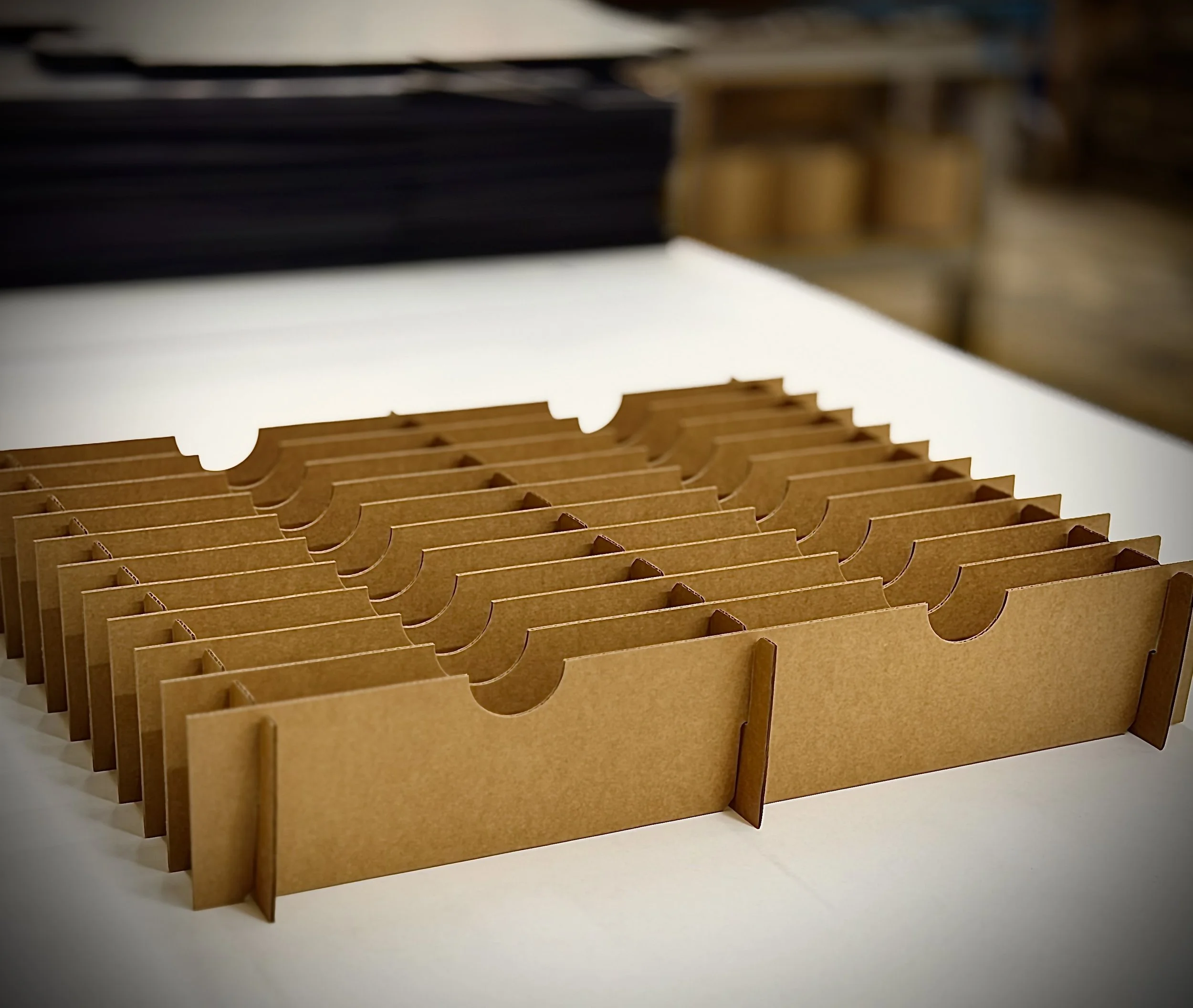 A brown cardboard organizer with multiple vertical slots, placed on a white surface.