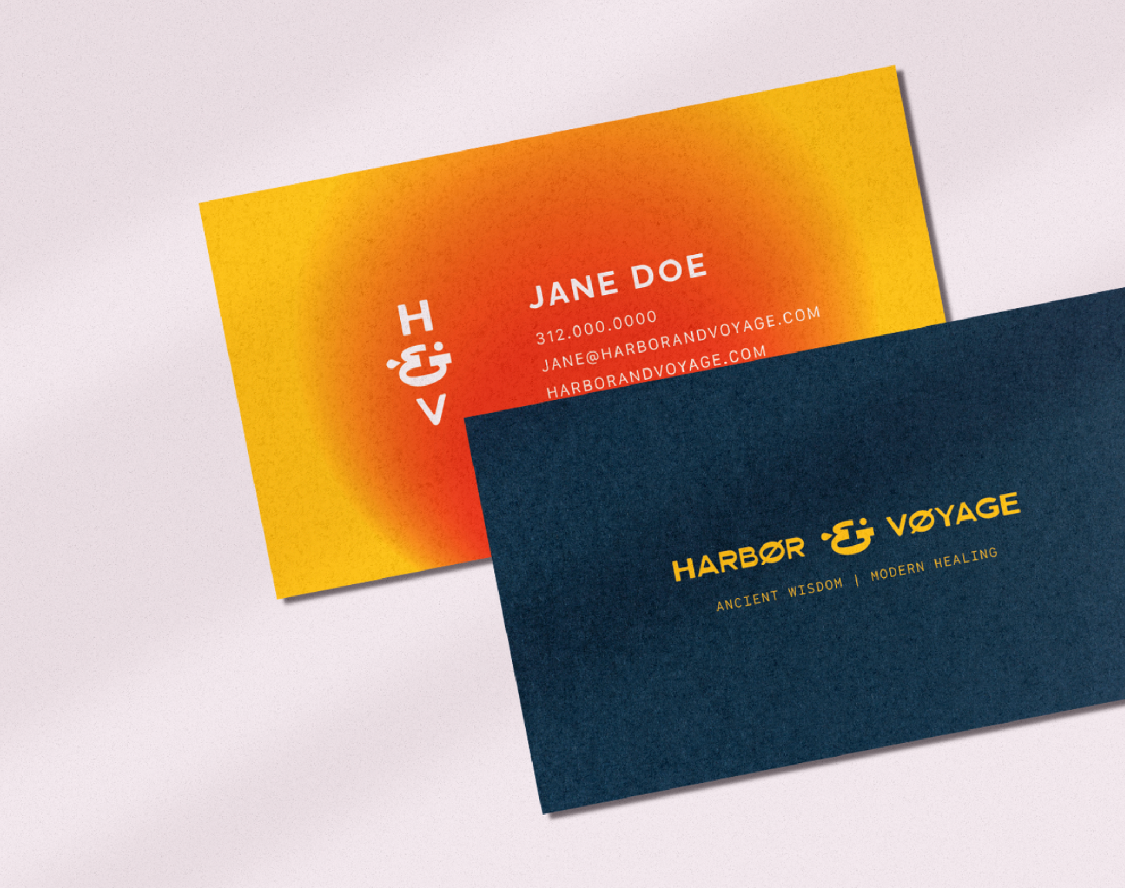 Two business cards with colorful gradient backgrounds, one yellow and red, the other dark blue. The cards display the logo 'Harbor & Voyage', a slogan, and contact information.