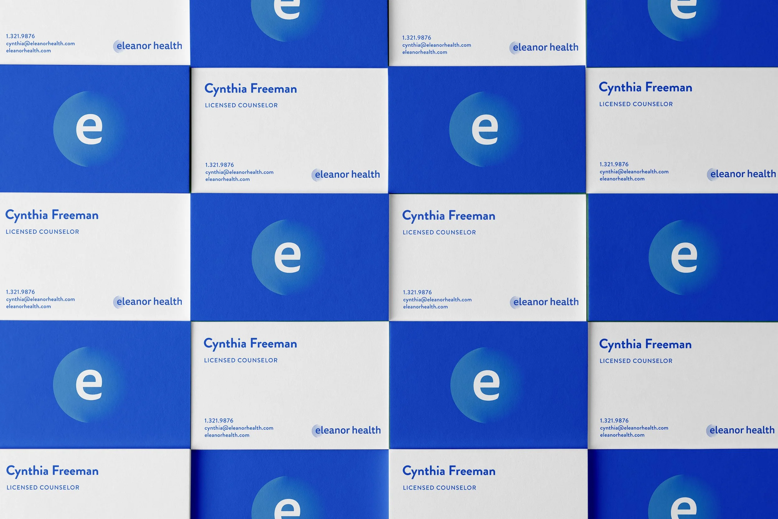 Business cards for Eleanor Health arranged in a grid pattern. The cards are primarily blue and white with the Eleanor Health logo and contact information.