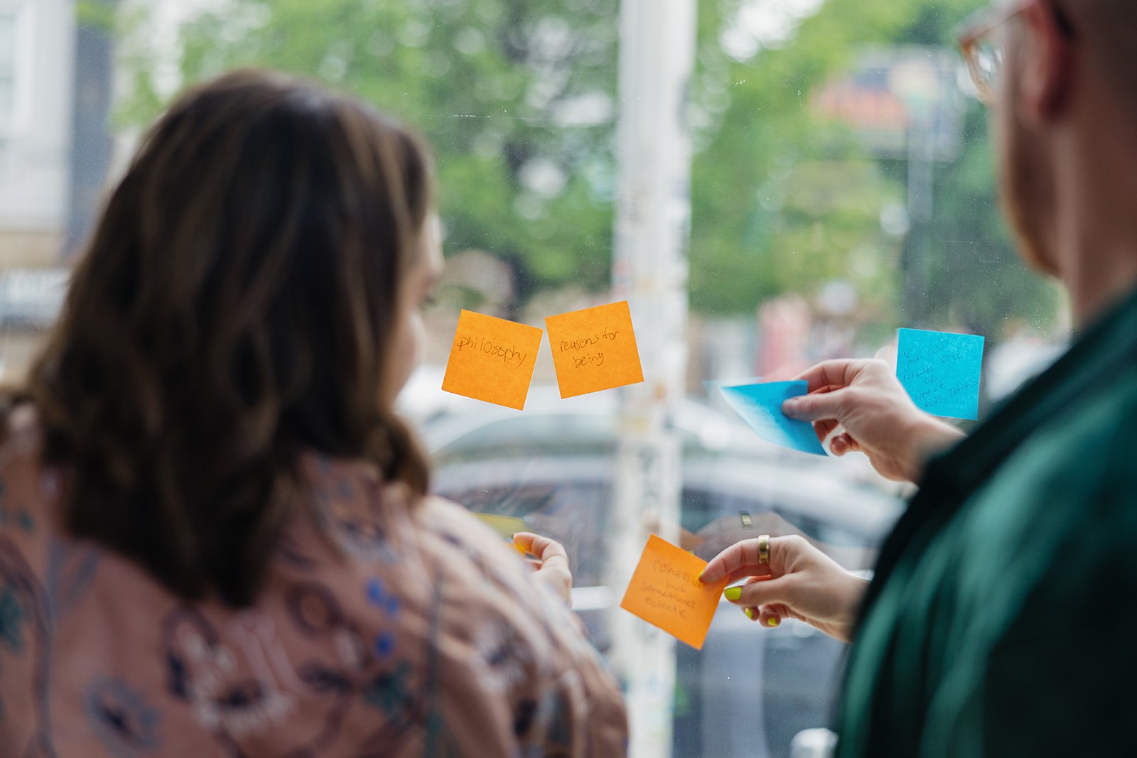 Magic Eight Co event participants writing thoughts on sticky notes