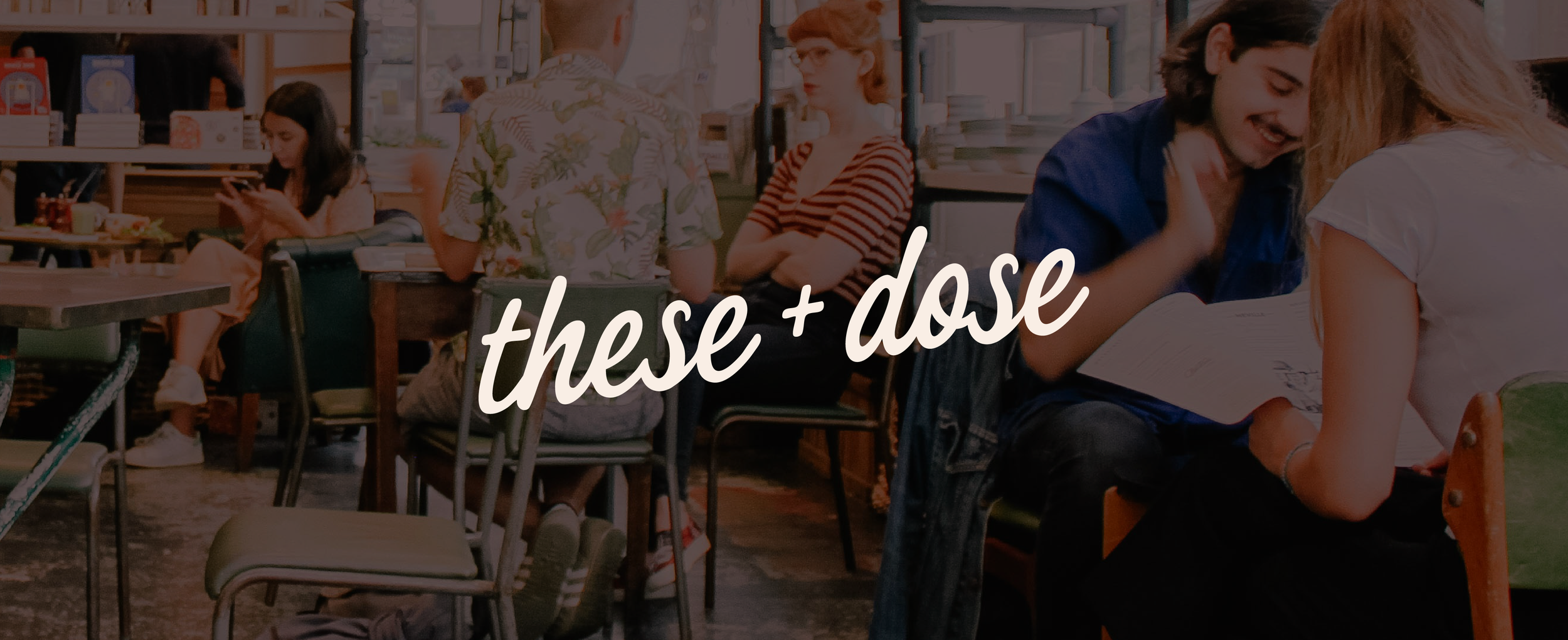 People sitting and talking in a cafe, with a woman using her phone in the background, and the words 'these + dose' overlaid on the image.