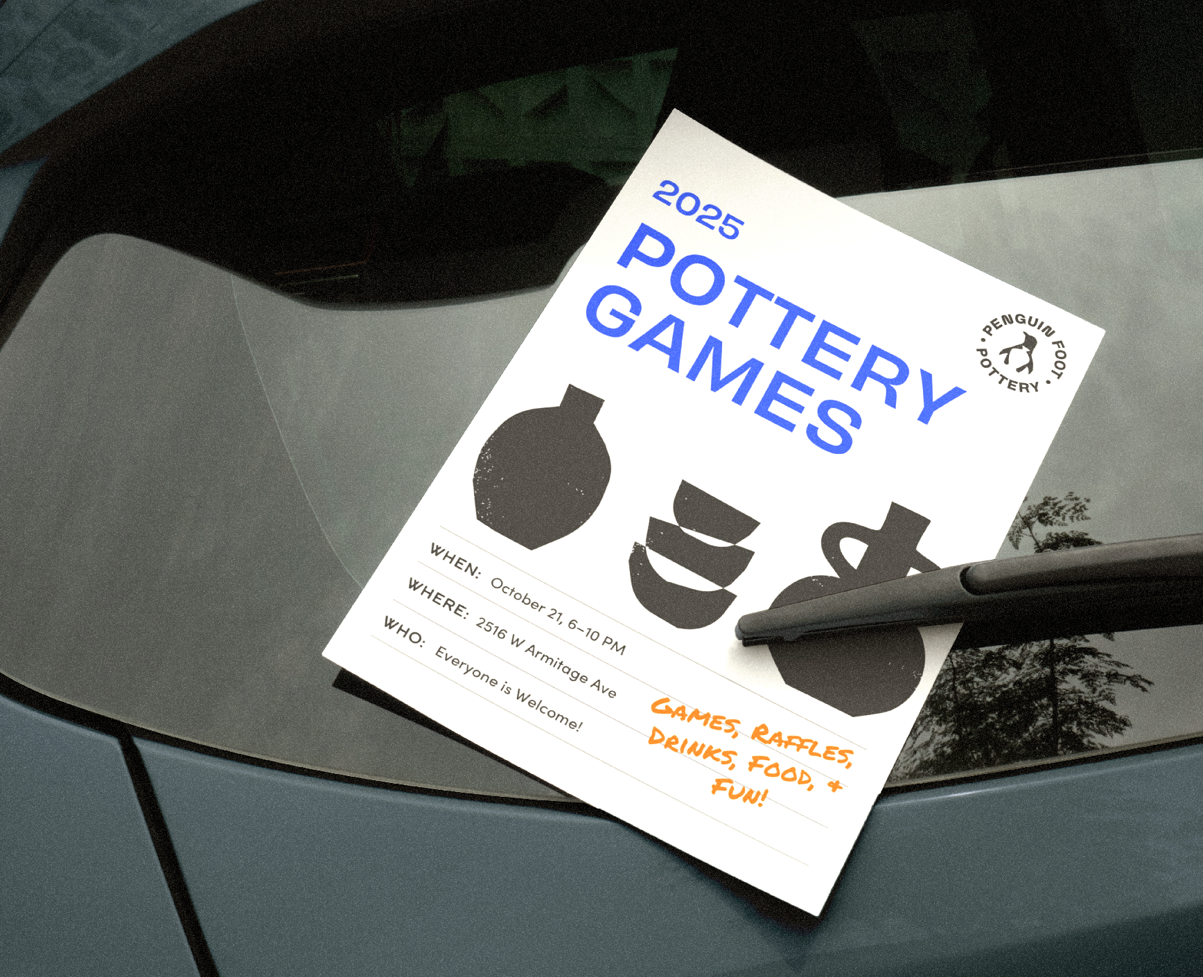 Flyer for a pottery games event on a car windshield, featuring black silhouettes of pottery items, with event details and orange handwriting promoting games, raffles, drinks, food, and fun.