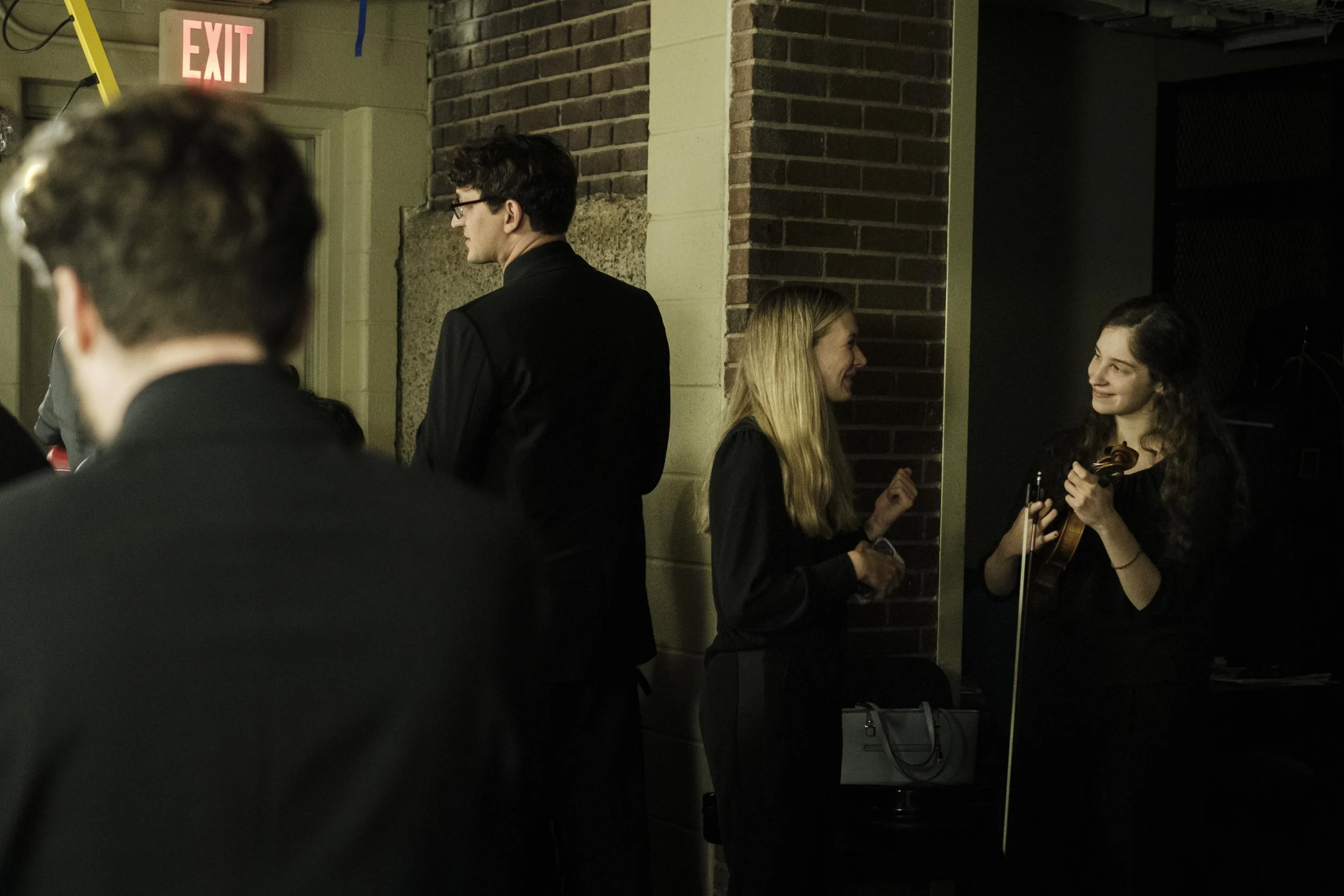 Musicians backstage at Hill Auditorium before the start of a concert by the Ann Arbor Symphony Orchestra