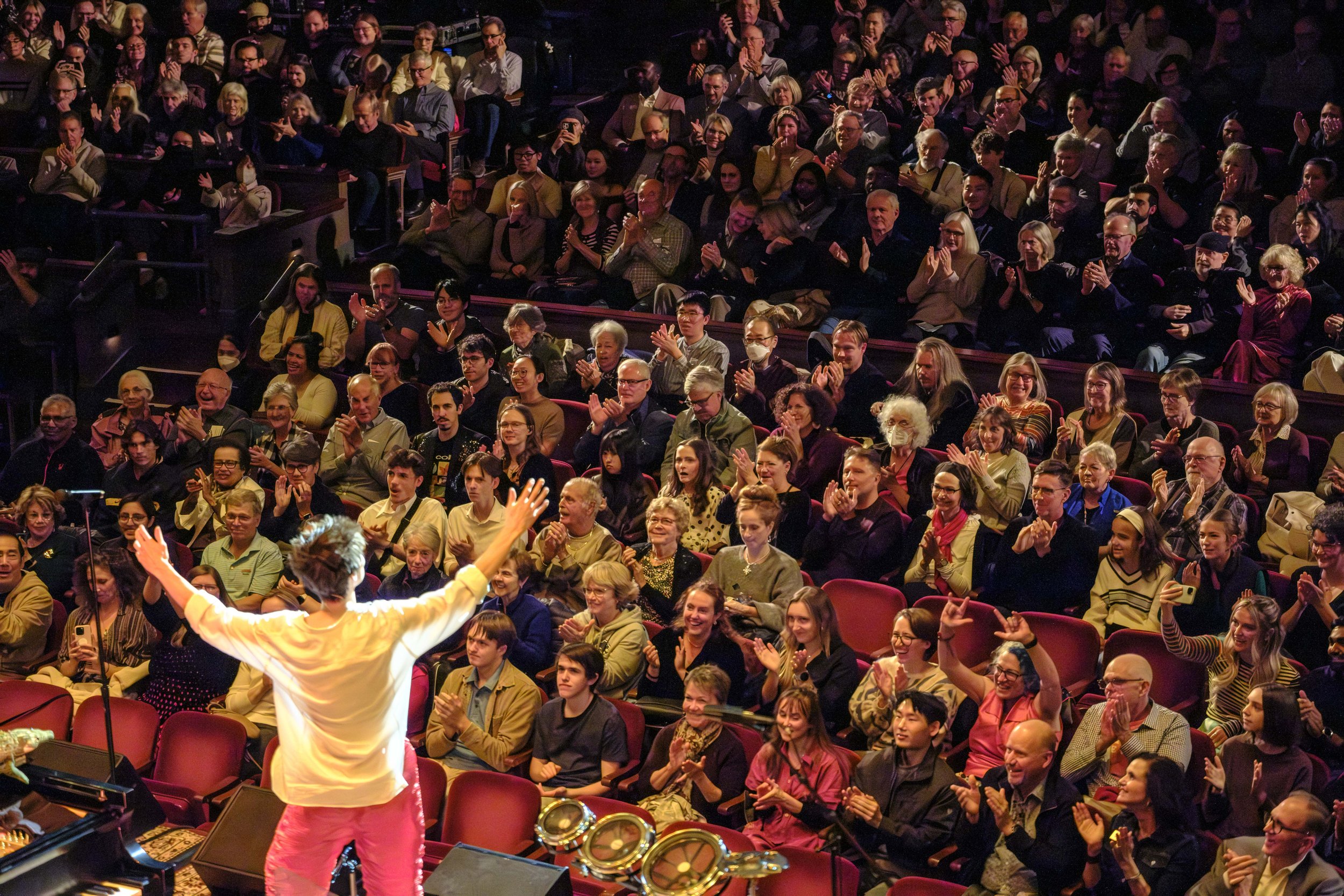 An audience applauds during a concert with Jacob Collier and the Ann Arbor Symphony Orchestra.