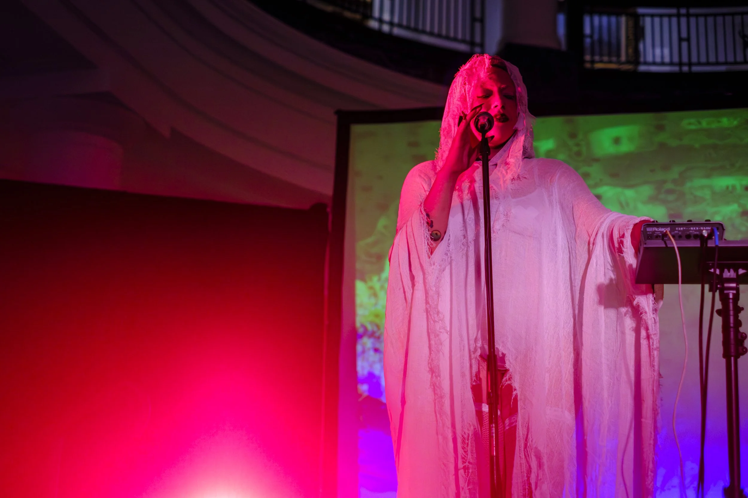 A musician plays music on stage at the University of Michigan Museum of Art Halloween Feel Good Friday Event Celebration.