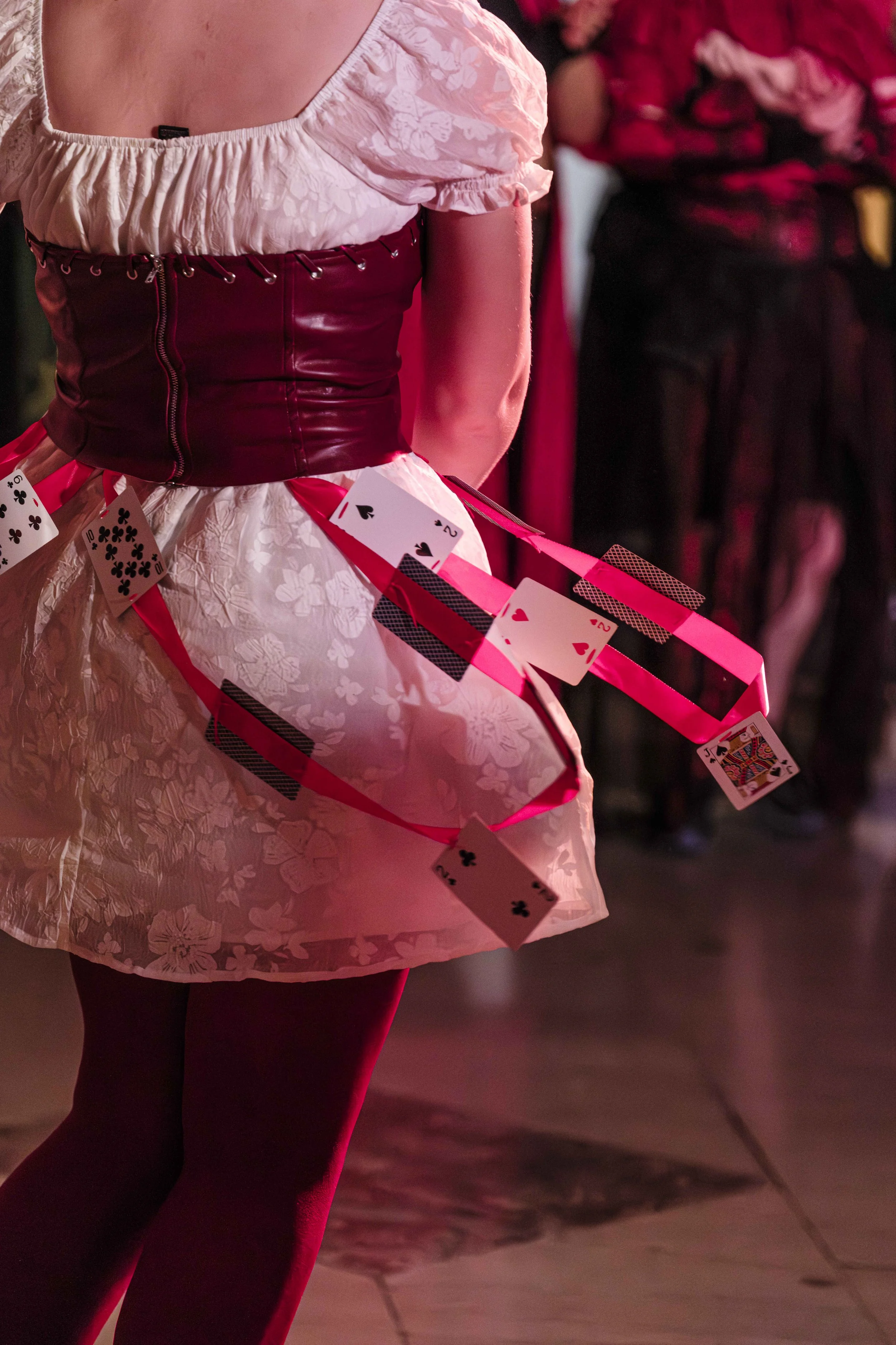 Cards taped to ribbon fly around in wind as a participant spins during the costume contest at the University of Michigan Museum of Art's Halloween costume contest.