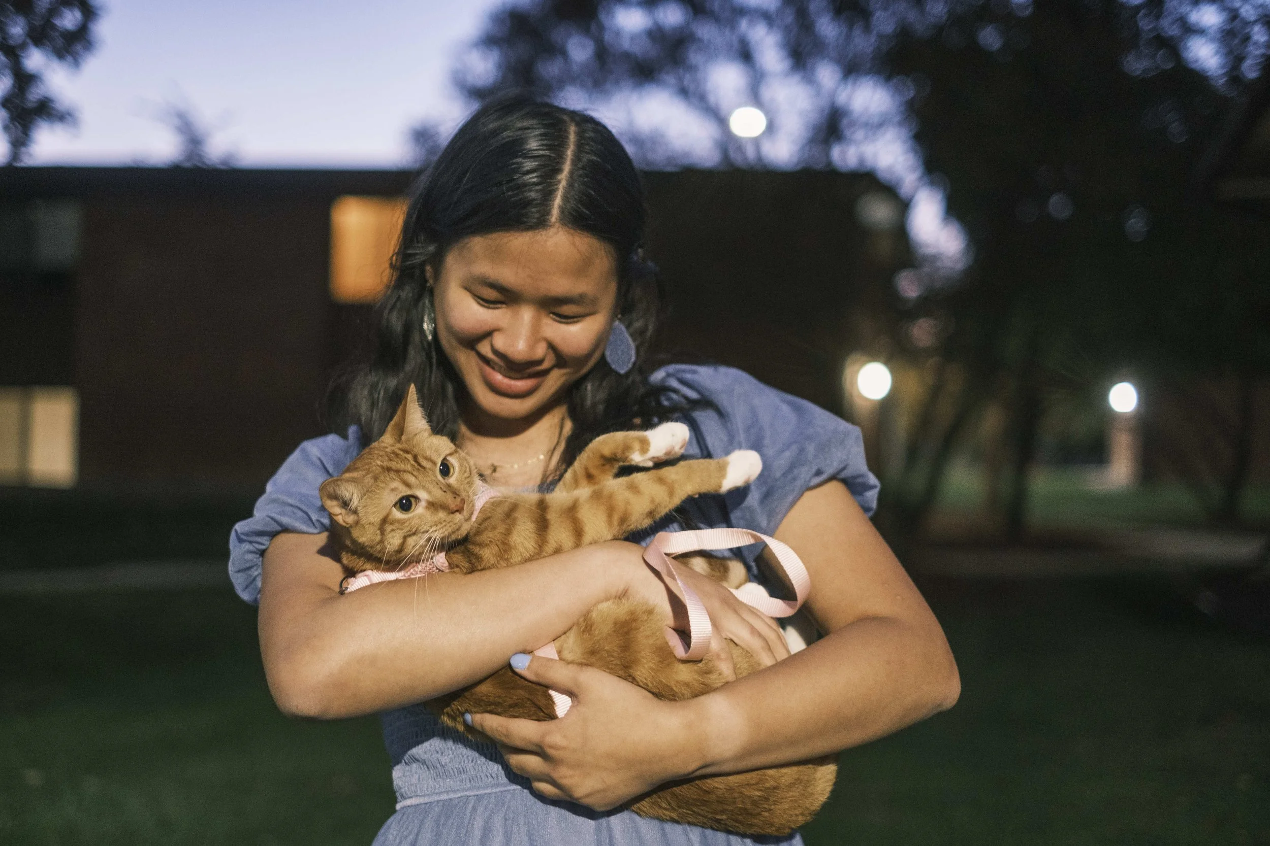 University of Michigan graduate hold her cat, Hazel outside her apartment.