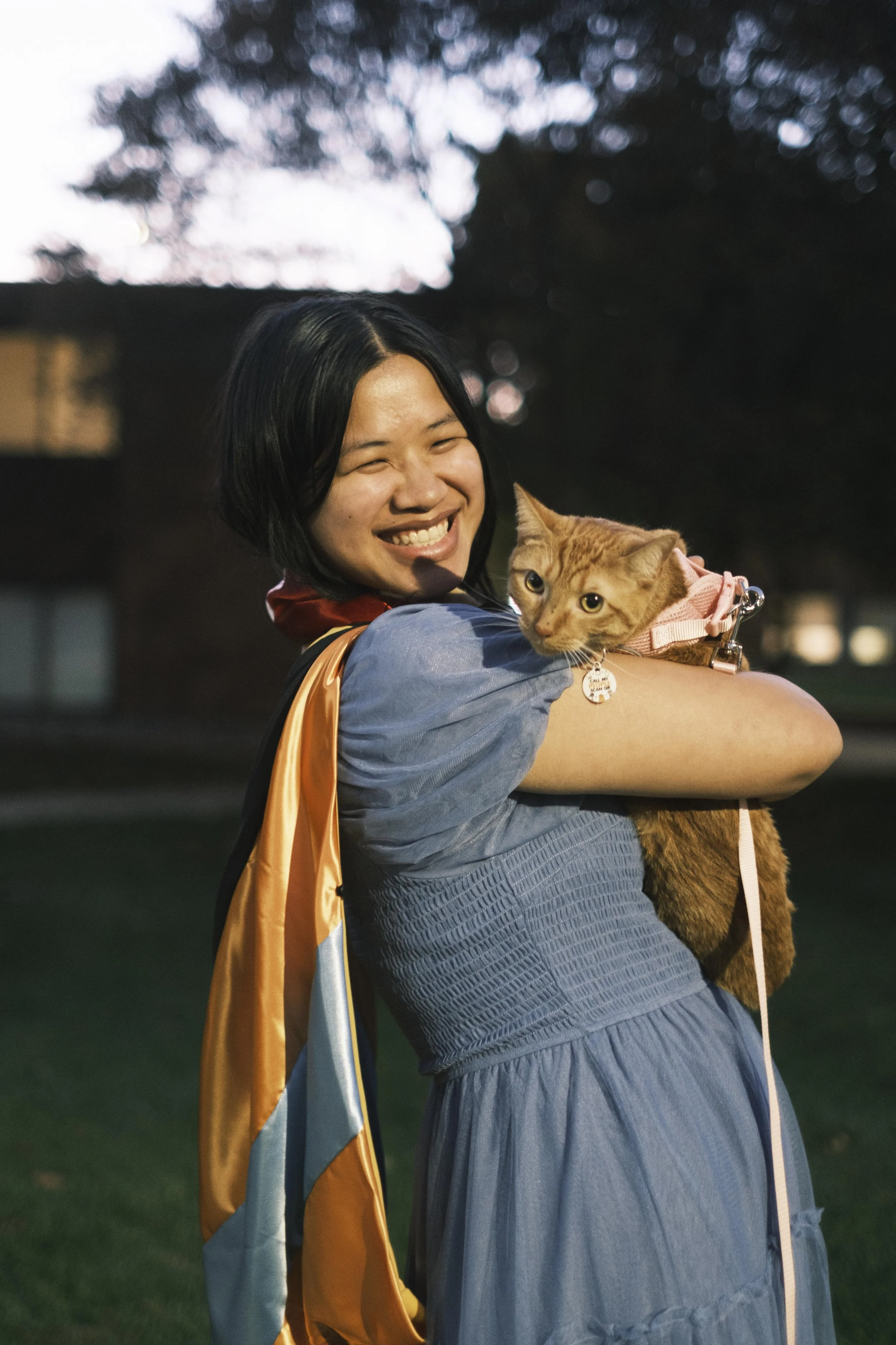A university graduate poses with her cat during a graduation photoshoot session in Ann Arbor, MI.