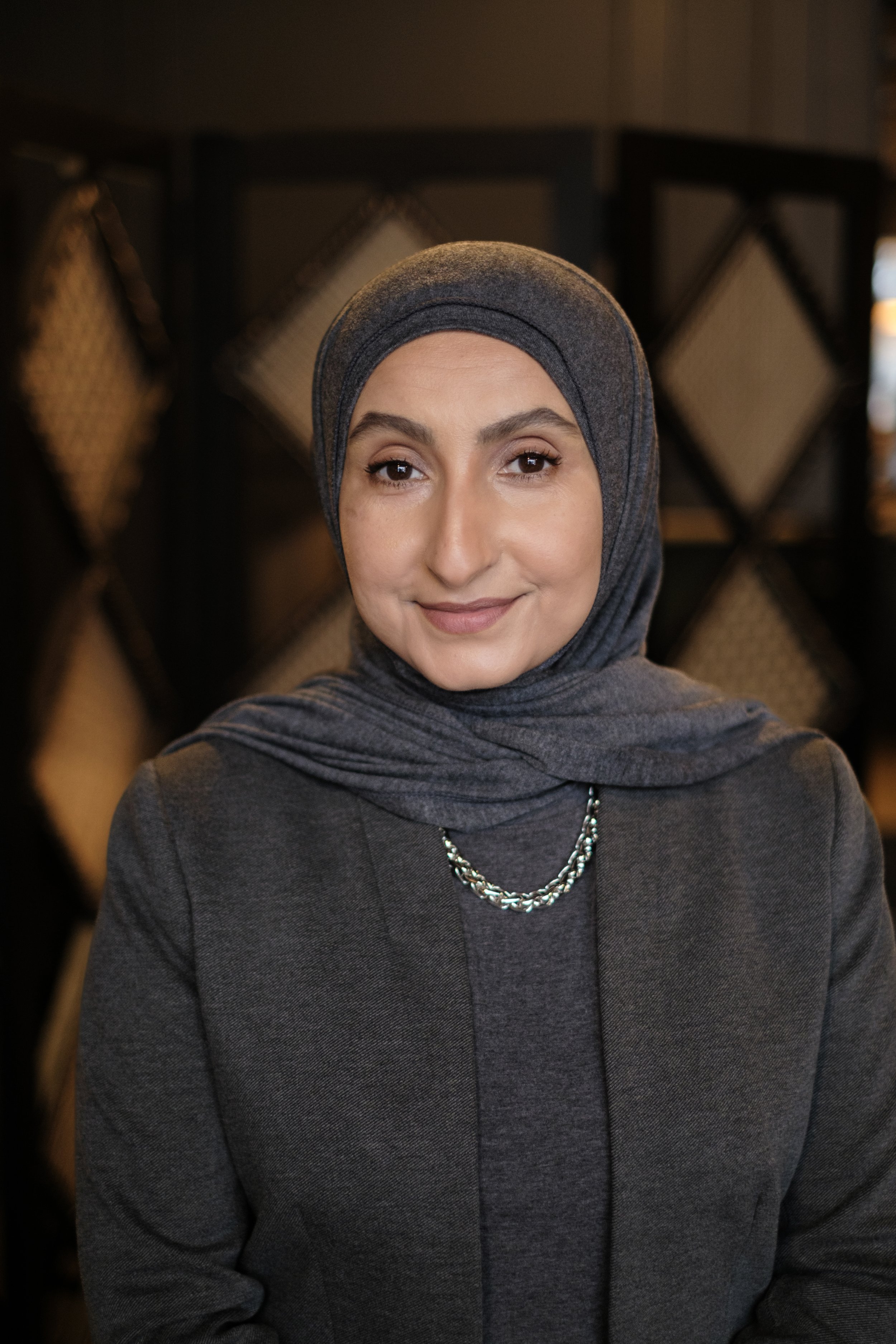 A headshot of a women in a hijab taken in Dearborn Michigan by Michigan Editorial Portrait Photographer Charlotte Smith