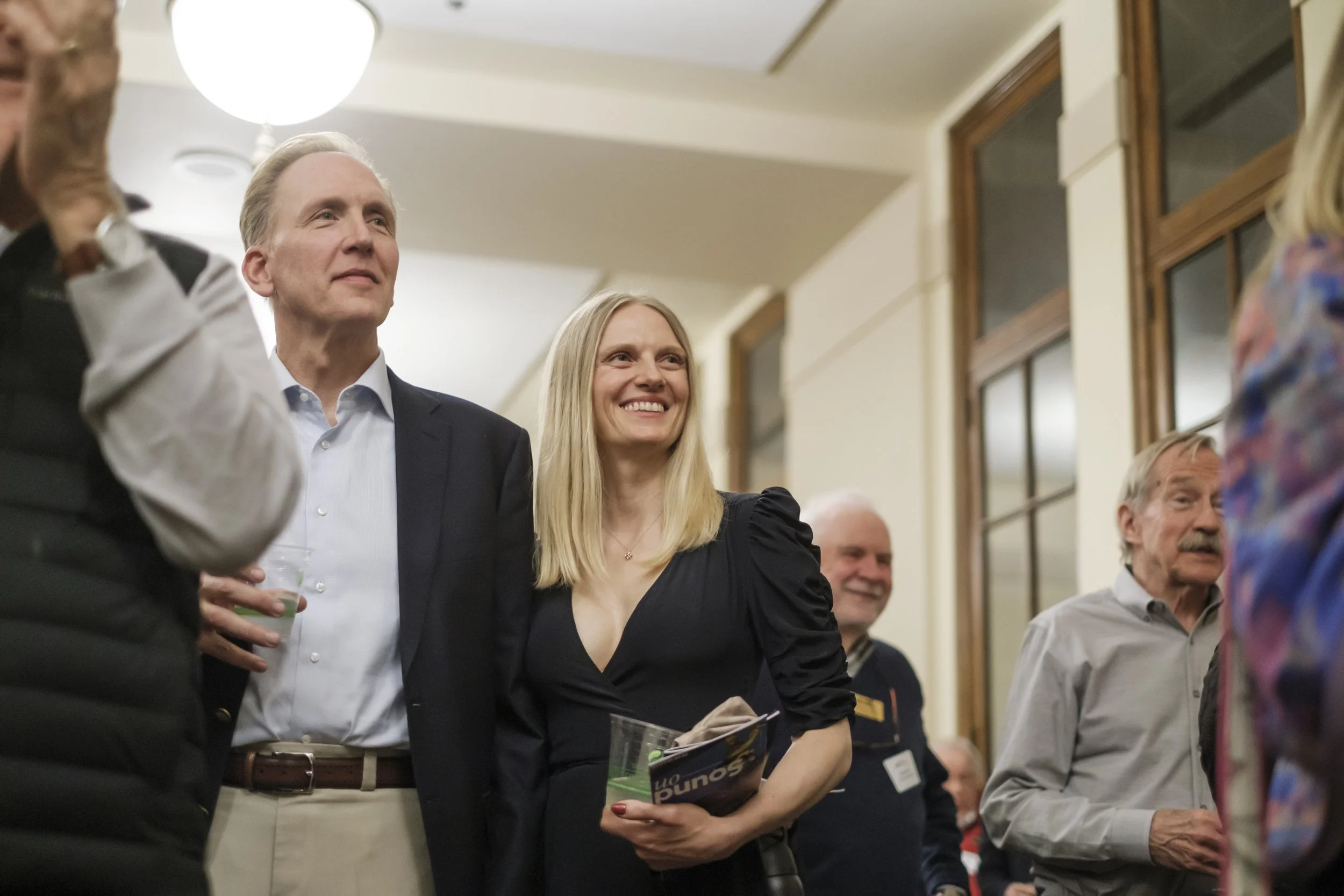 A woman smiling in the audience while attending the Ann Arbor Symphony Orchestra Afterglow event.