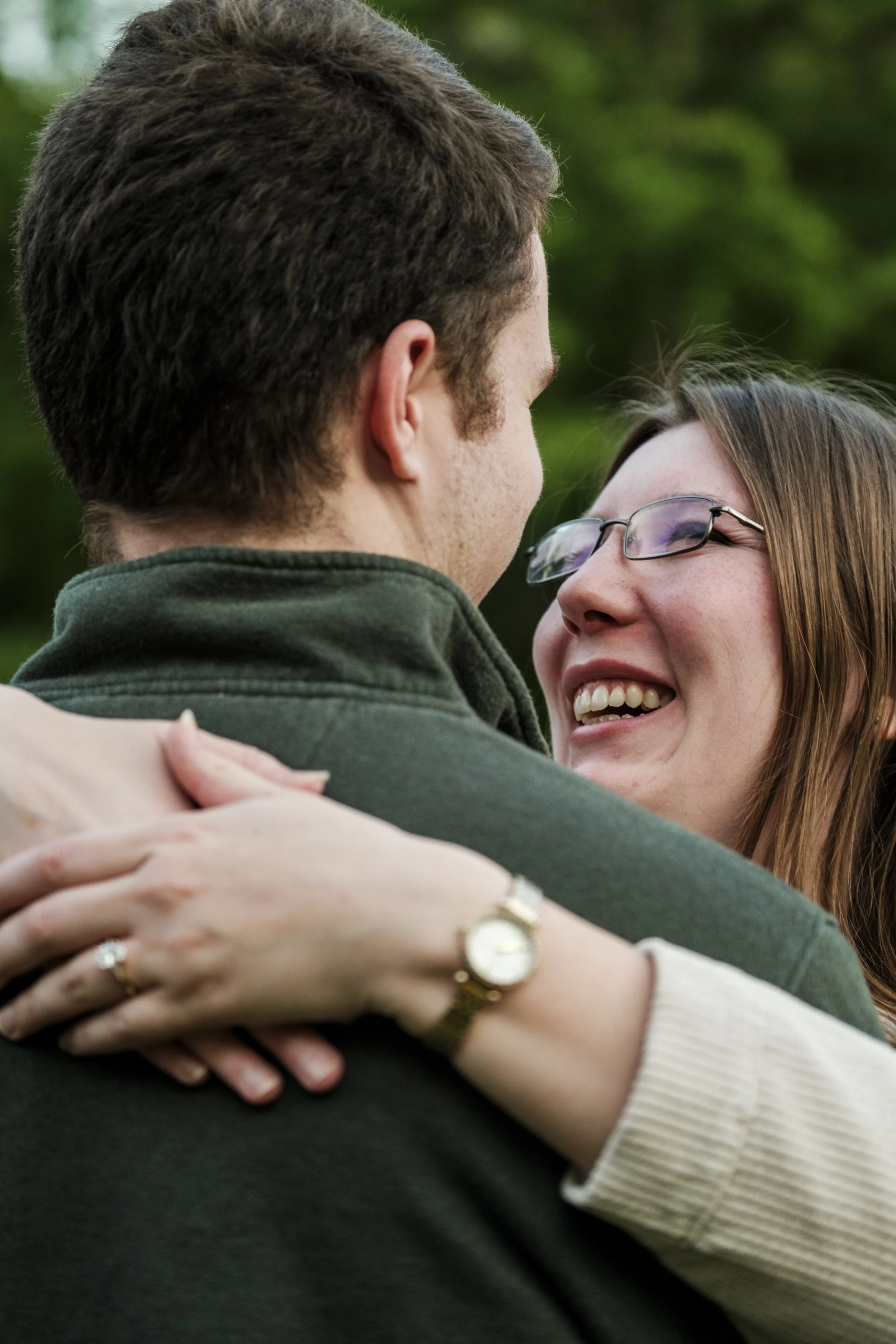 A woman looks up at a man while laughing.