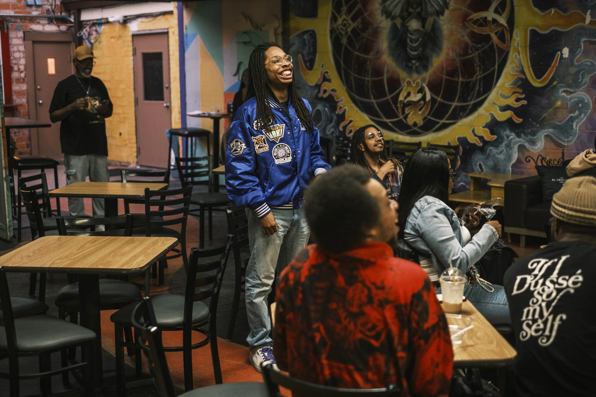 Poet RJMC smiles during JJ's Homecoming and Open Mic poetry slam event at Artist Village in Detroit