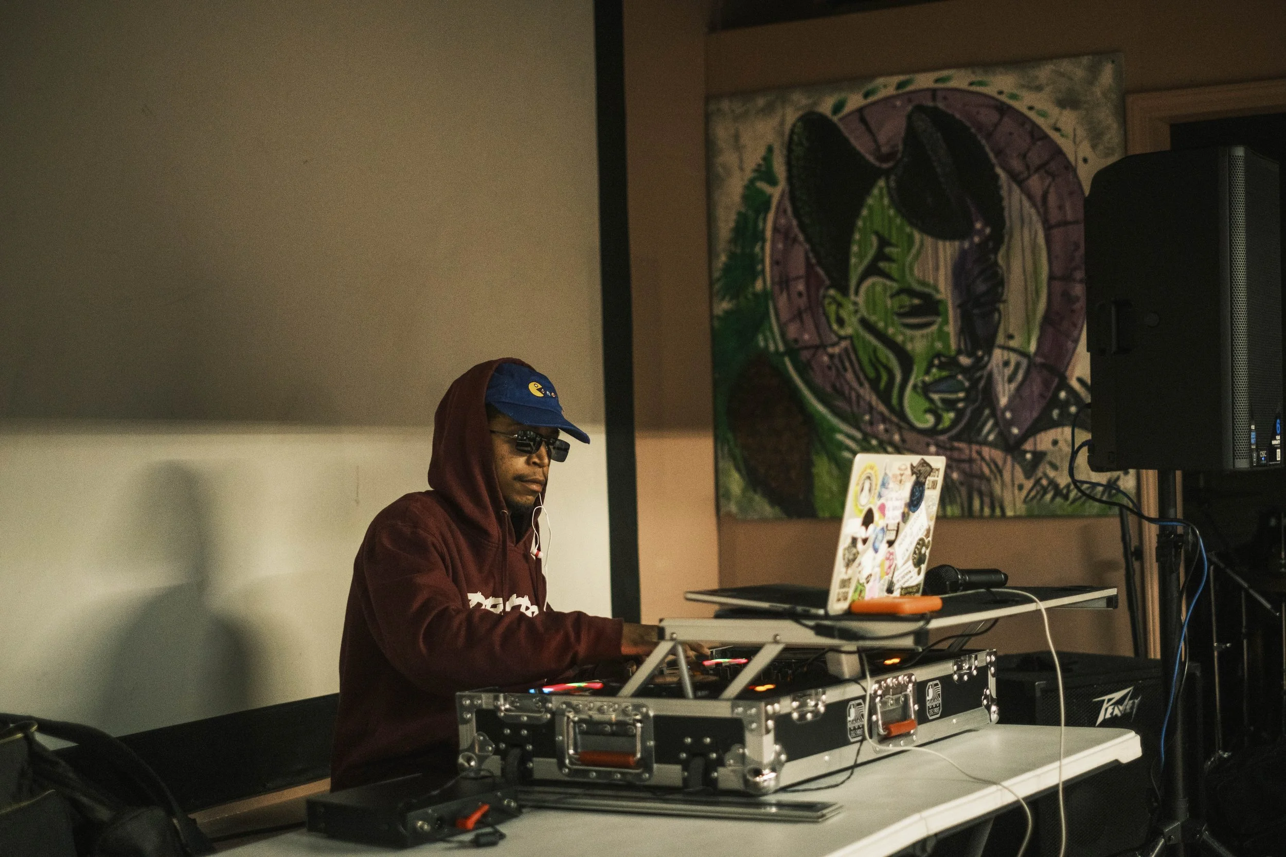 A DJ spins records during a poetry event at Artist Village in Detroit, michigan.