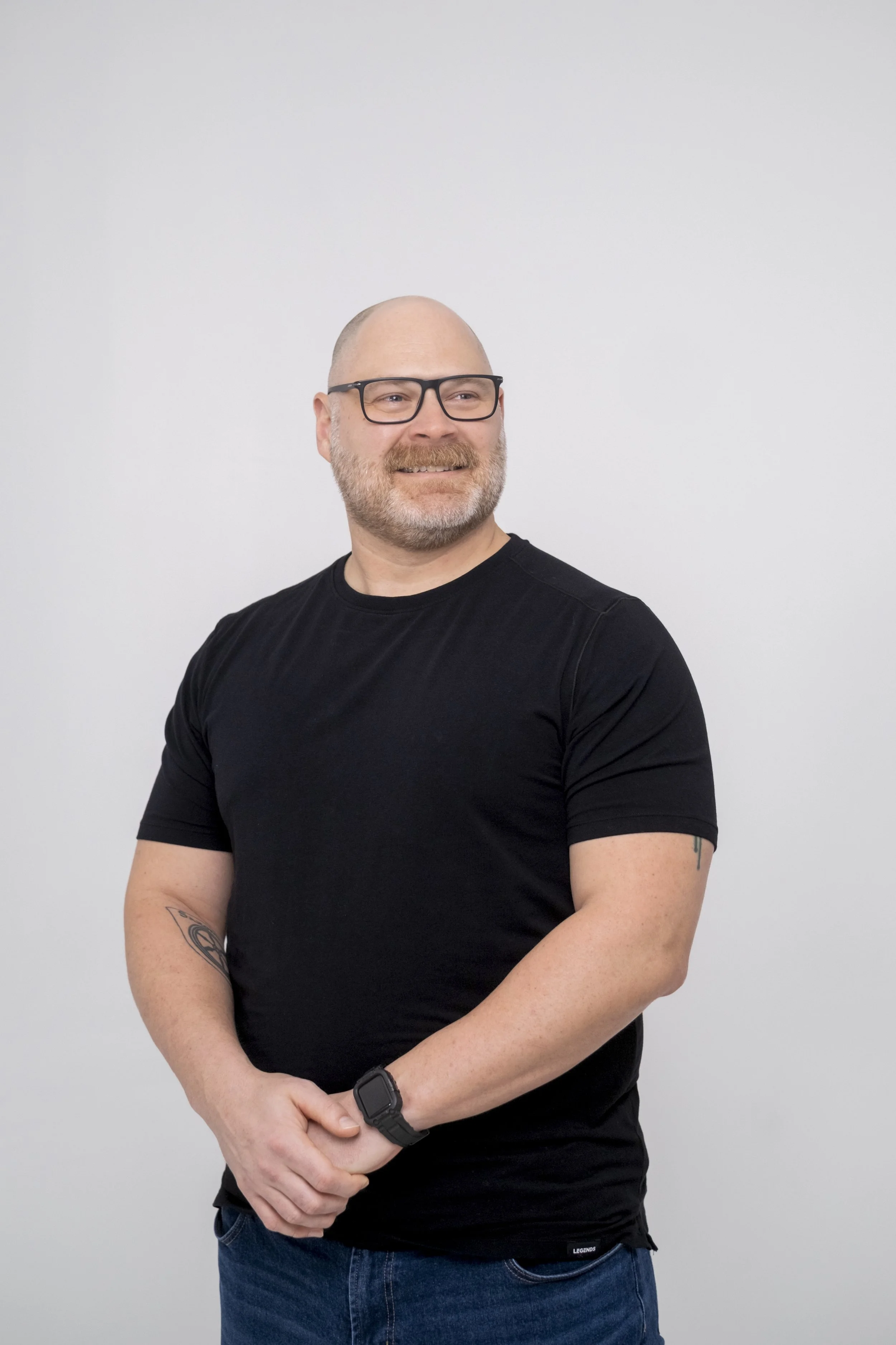 A candid portrait of a man wearing glasses at StudioStudio, a studio space in Ann Arbor, Michigan